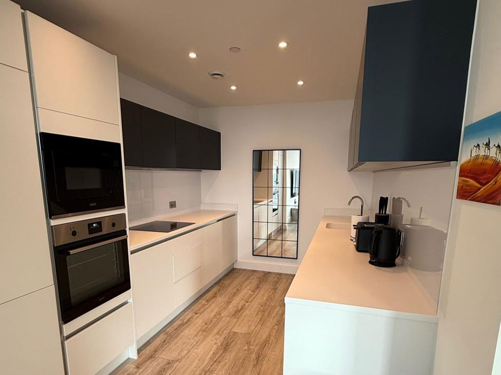 A kitchen with cabinets, sink, and appliances at 3 Bed Apartment, sleeping 6 with Wifi, Manchester