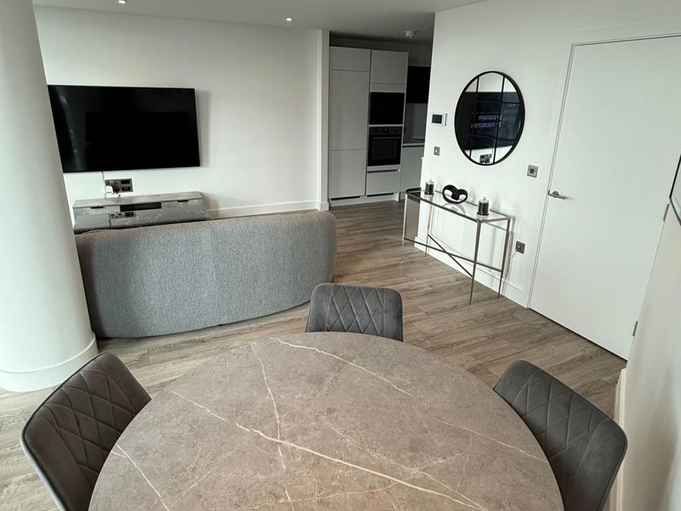 A dining room with a table and chairs at 3 Bed Apartment, sleeping 6 with Wifi Manchester