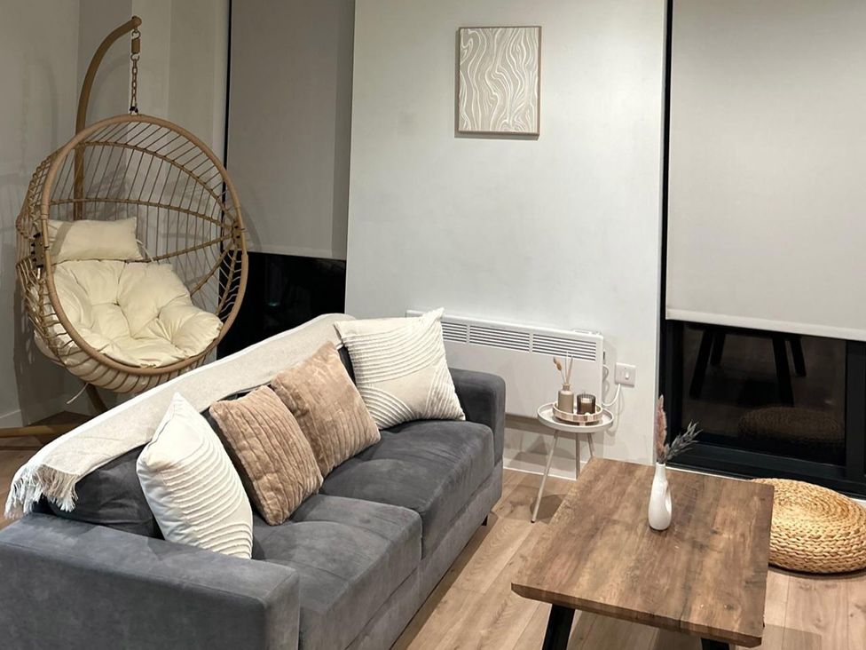 A living room with a hanging chair and a sofa at Central Apartment with Free Parking, Terrace and Gym, Manchester