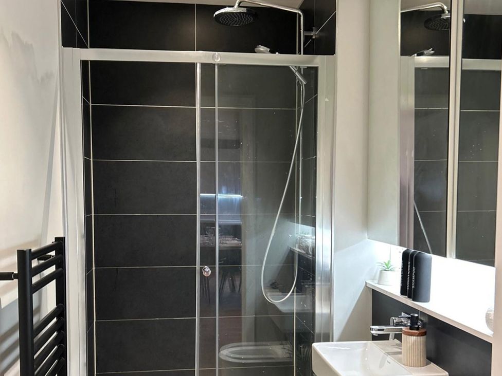 A bathroom with a shower and sink at Central Apartment with Free Parking, Terrace and Gym, Manchester
