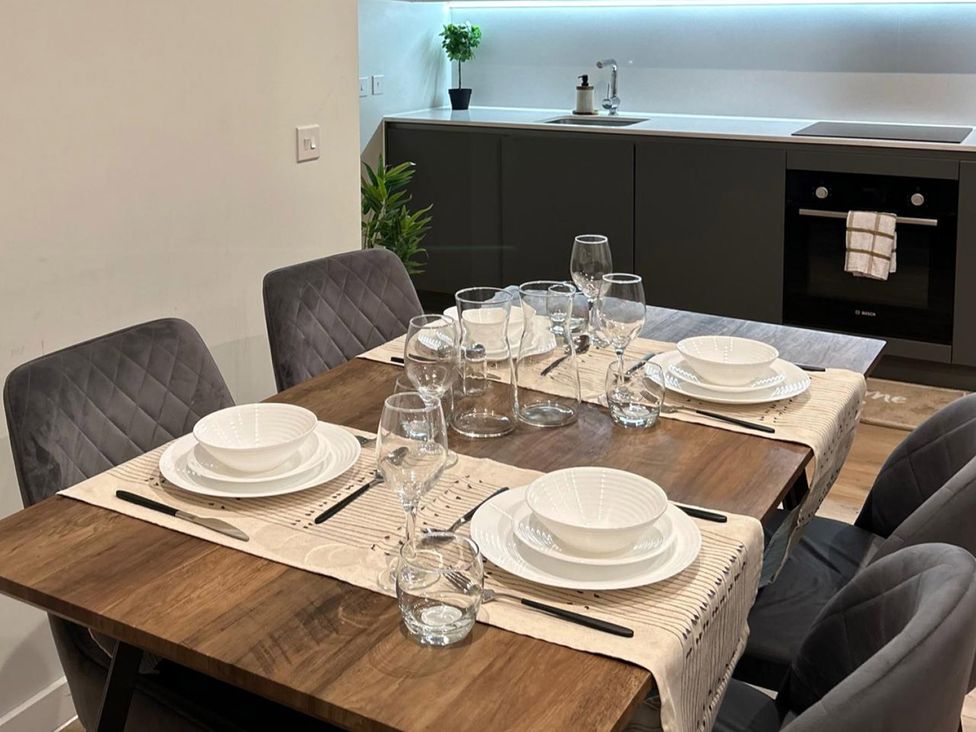 A dining room with a table set for a meal at Central Apartment with Free Parking, Terrace and Gym in Manchester