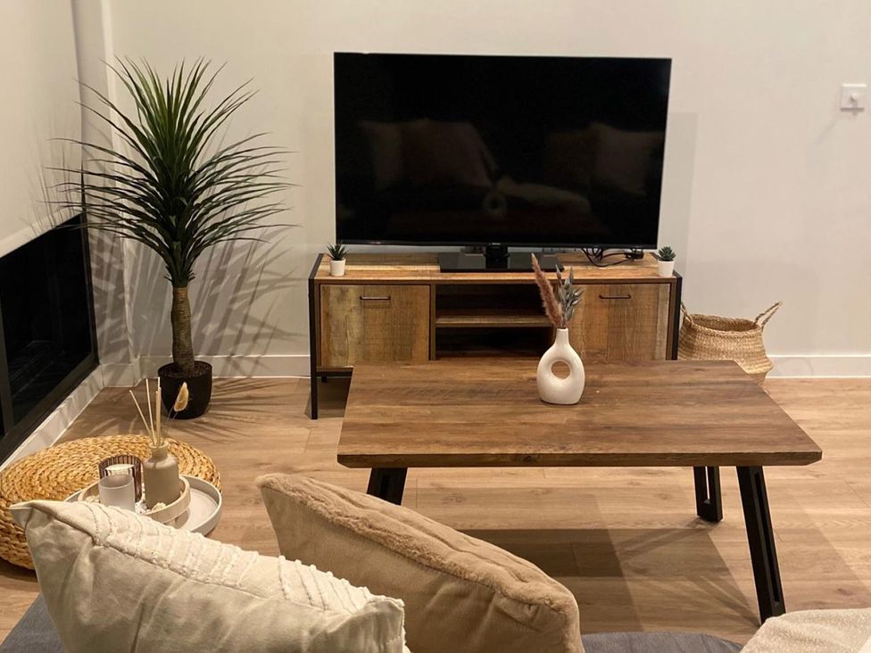 A living room with a coffee table and television at Central Apartment with Free Parking, Terrace and Gym in Manchester