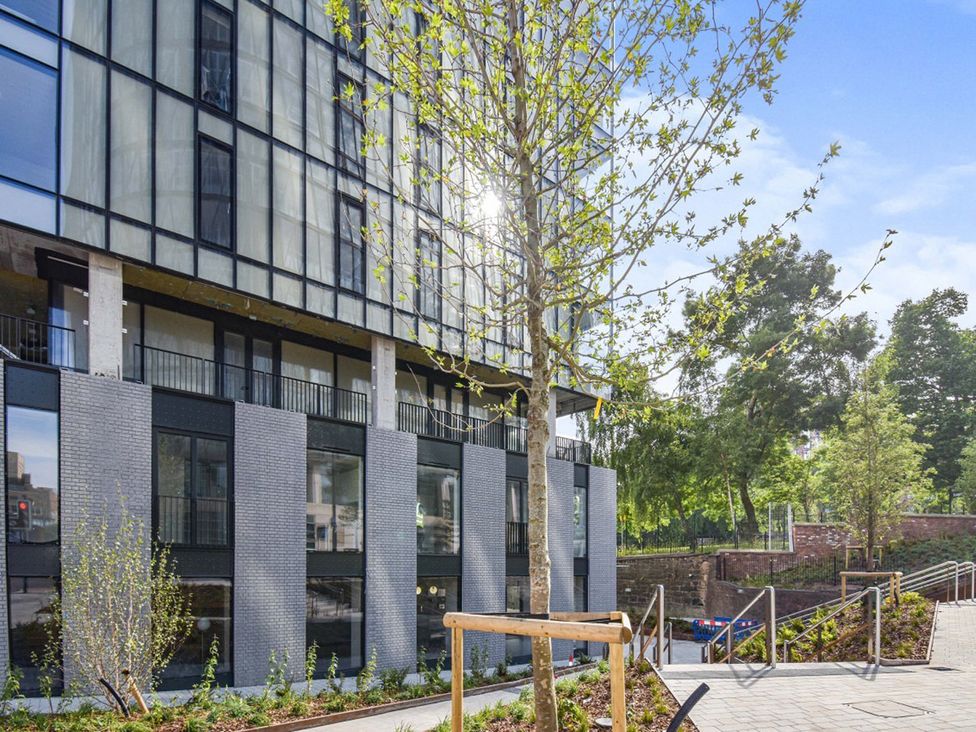 An exterior view of a building with trees and a pathway at Central Apartment with Free Parking, Terrace and Gym in Manchester