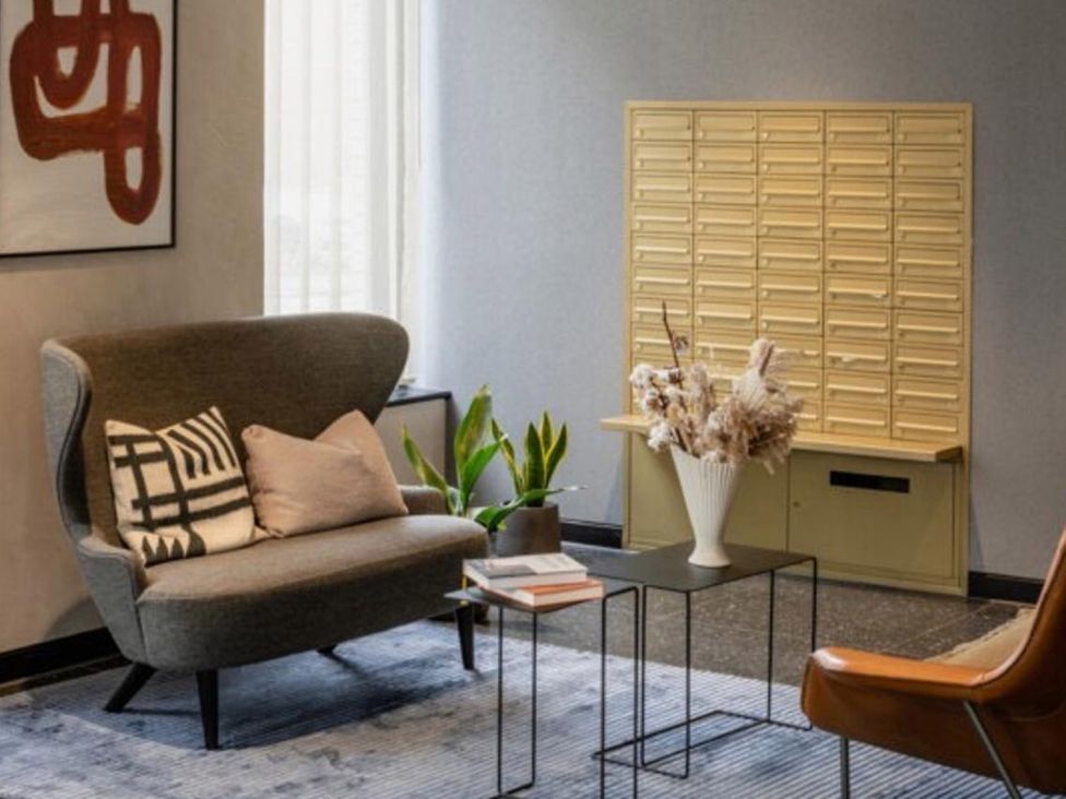 A lobby with seating and a mail delivery system at Central Apartment with Free Parking, Terrace and Gym Manchester