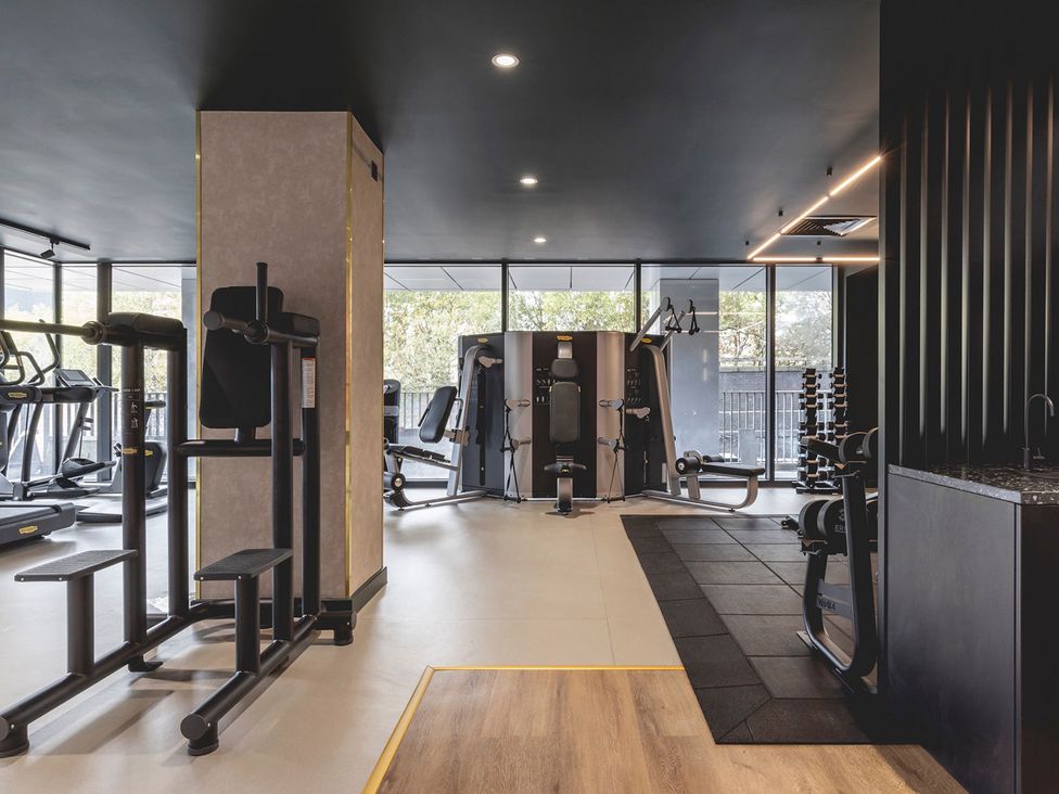 A gym with various fitness equipment at Central Apartment with Free Parking, Terrace and Gym in Manchester