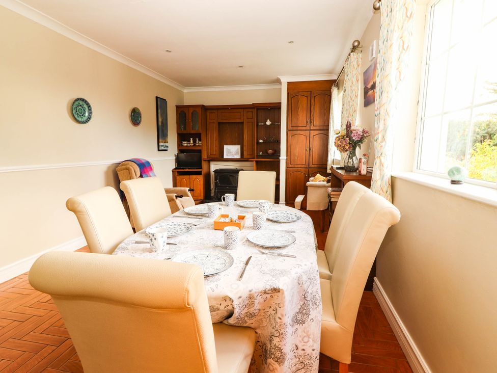 A dining room with a table set for dinner at Cross Beg in Kilmihil, County Clare