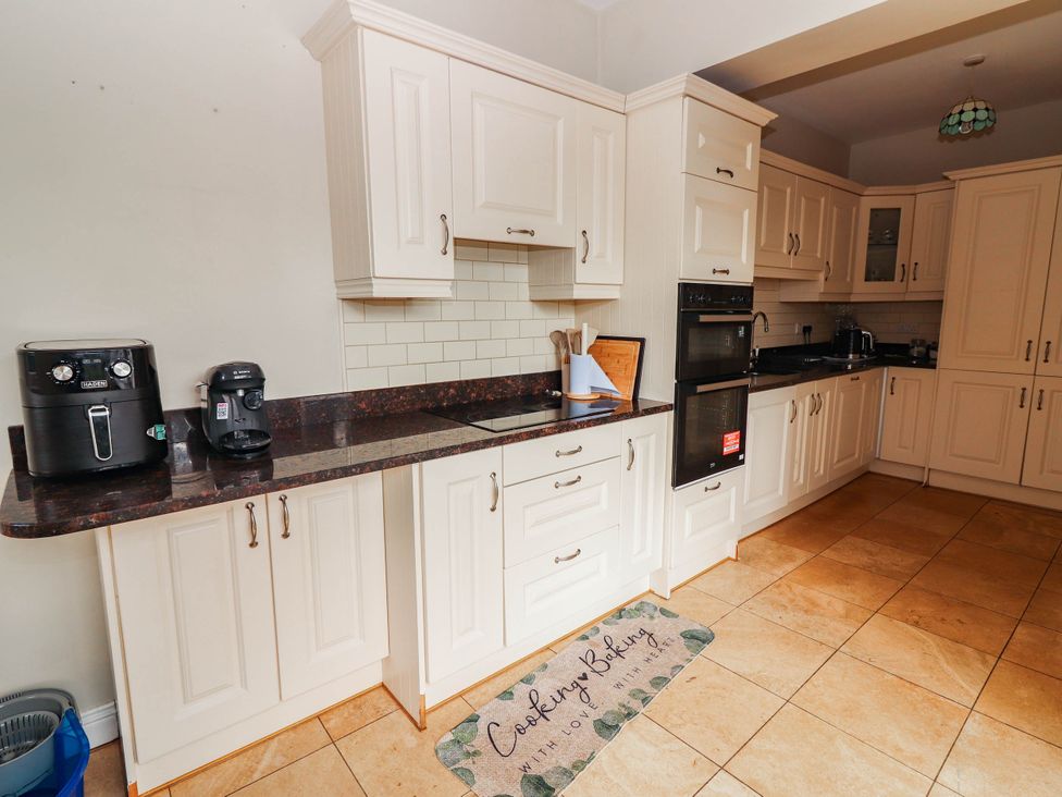 A kitchen with appliances and cabinets at Cross Beg in Kilmihil, County Clare