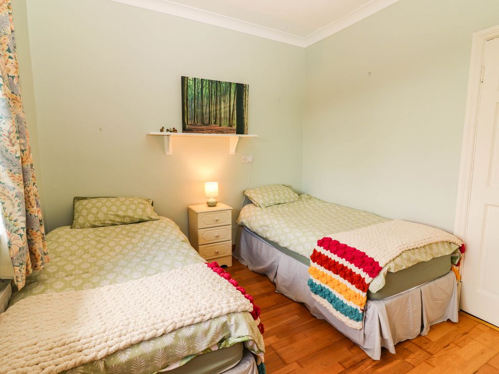 A bedroom with two beds and a nightstand at Cross Beg, Kilmihil, County Clare