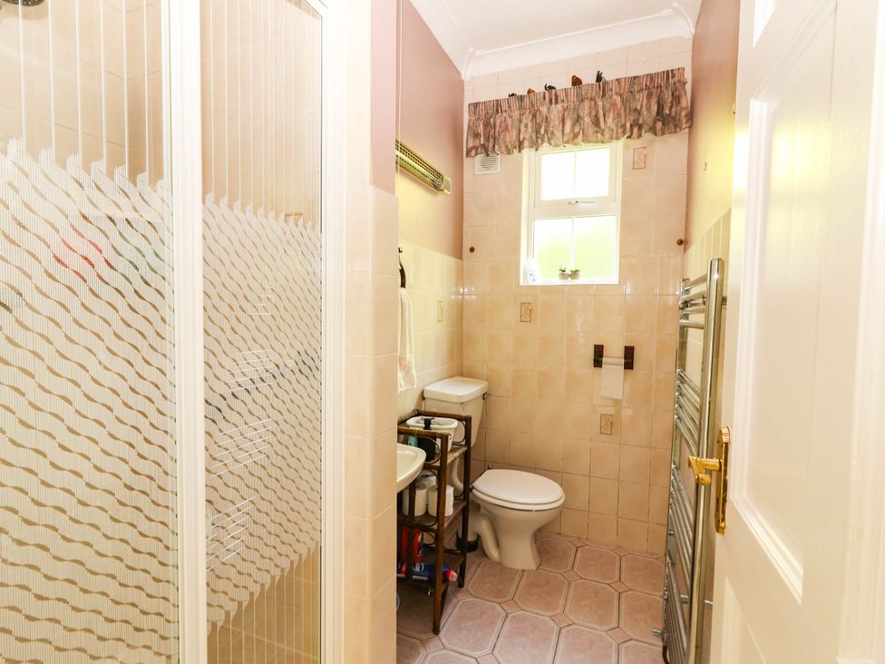 A bathroom with a shower, toilet, and sink at Cross Beg, Kilmihil, County Clare
