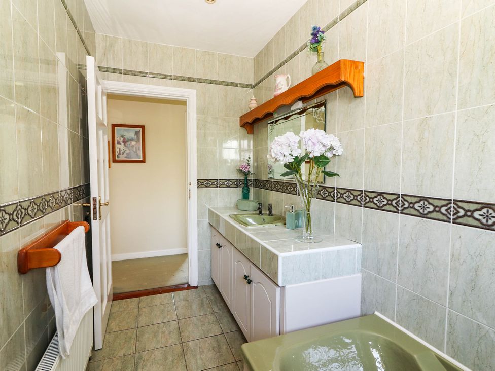 A bathroom with a sink and mirror at Cross Beg Kilmihil, County Clare