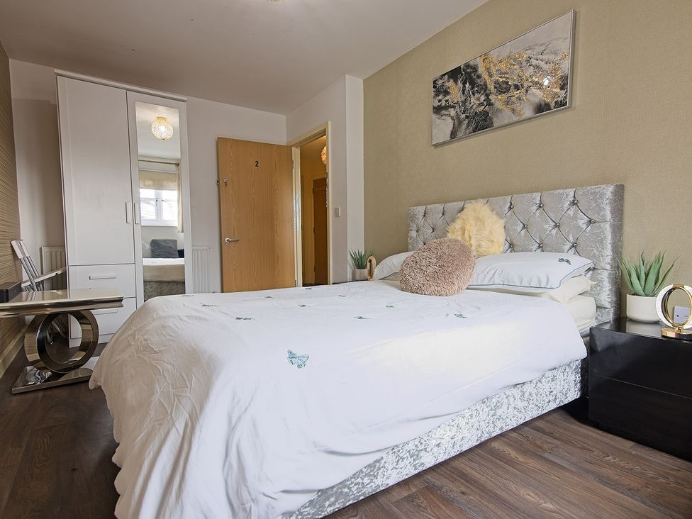 A bedroom with a bed and wardrobe at 2 Bedroom Apartment in Manchester