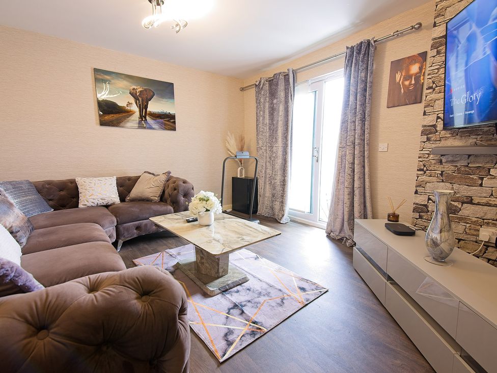 A living room with a sofa and coffee table at 2 Bedroom Apartment in Manchester