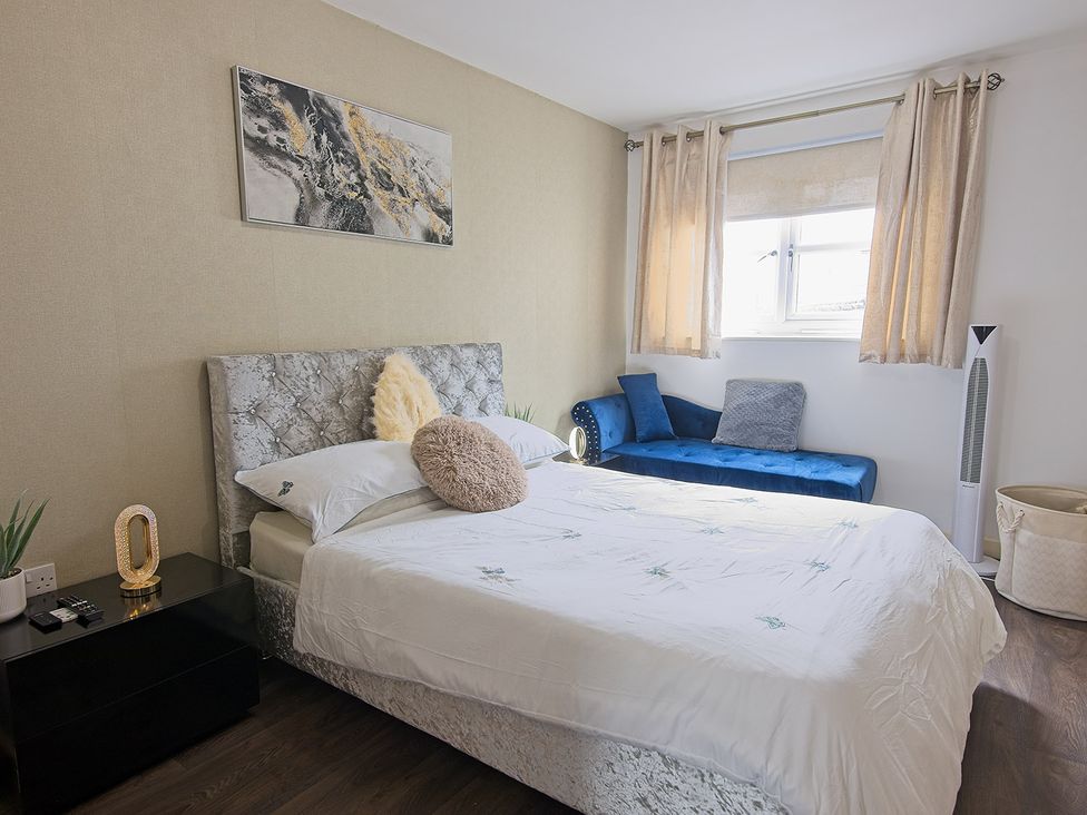 A bedroom with bed and sofa at 2 Bedroom Apartment in Manchester