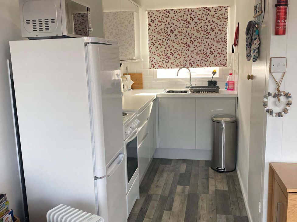 A kitchen with a refrigerator and oven at Chalet 359 in Hemsby
