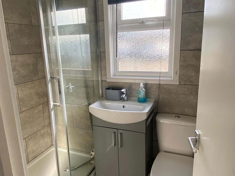 A bathroom with a shower and sink at Chalet 359 in Hemsby