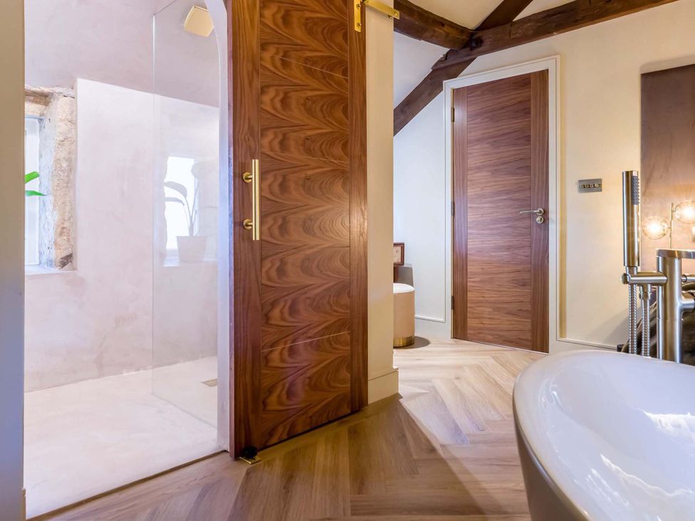 A bathroom with a shower and bathtub at Heaven Lea Cottage
