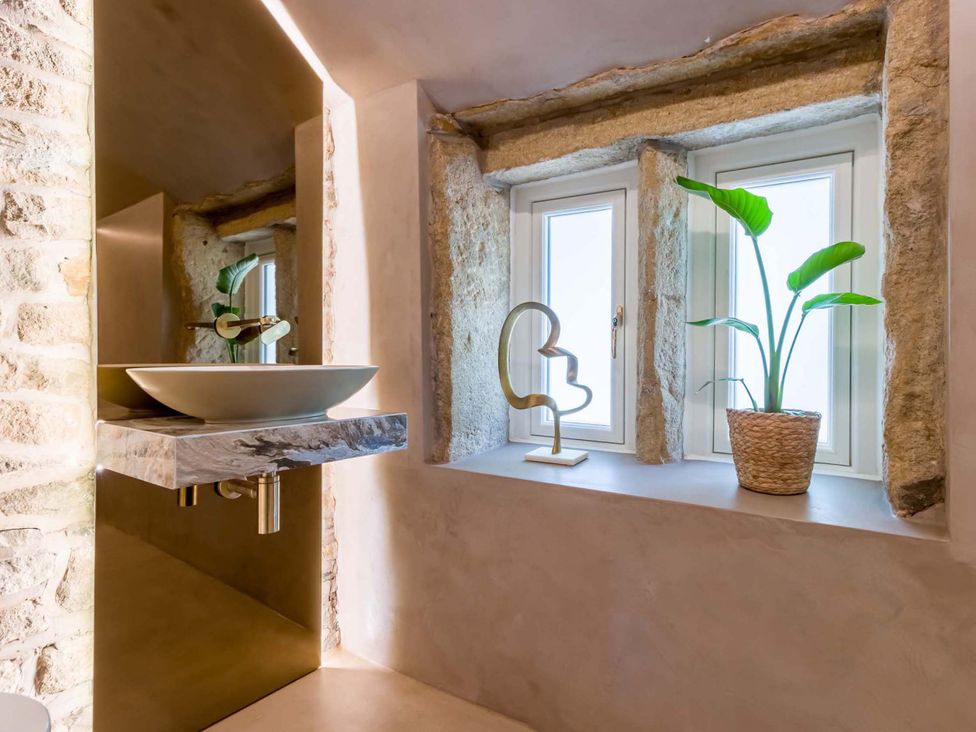A bathroom with a sink and windows at Heaven Lea Cottage