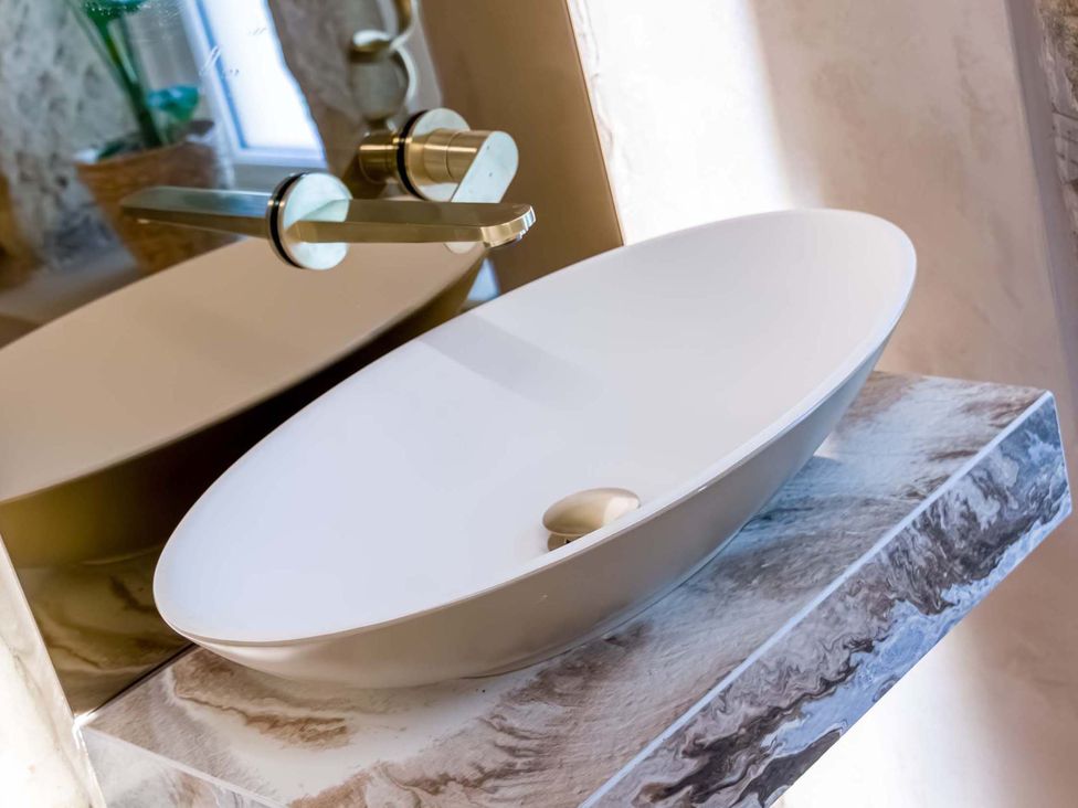A sink with a faucet on a countertop in Heaven Lea Cottage