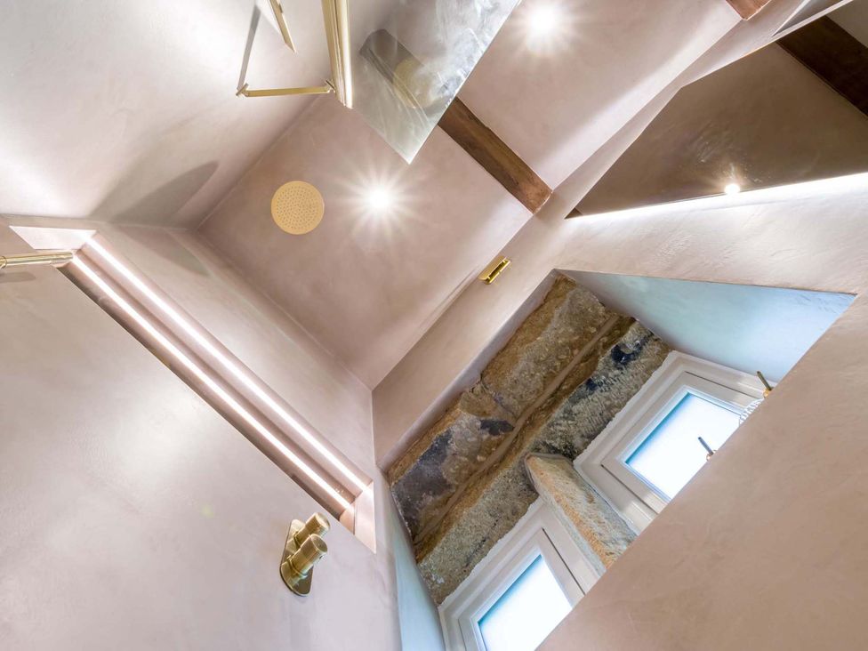A bathroom with ceiling light and windows at Heaven Lea Cottage