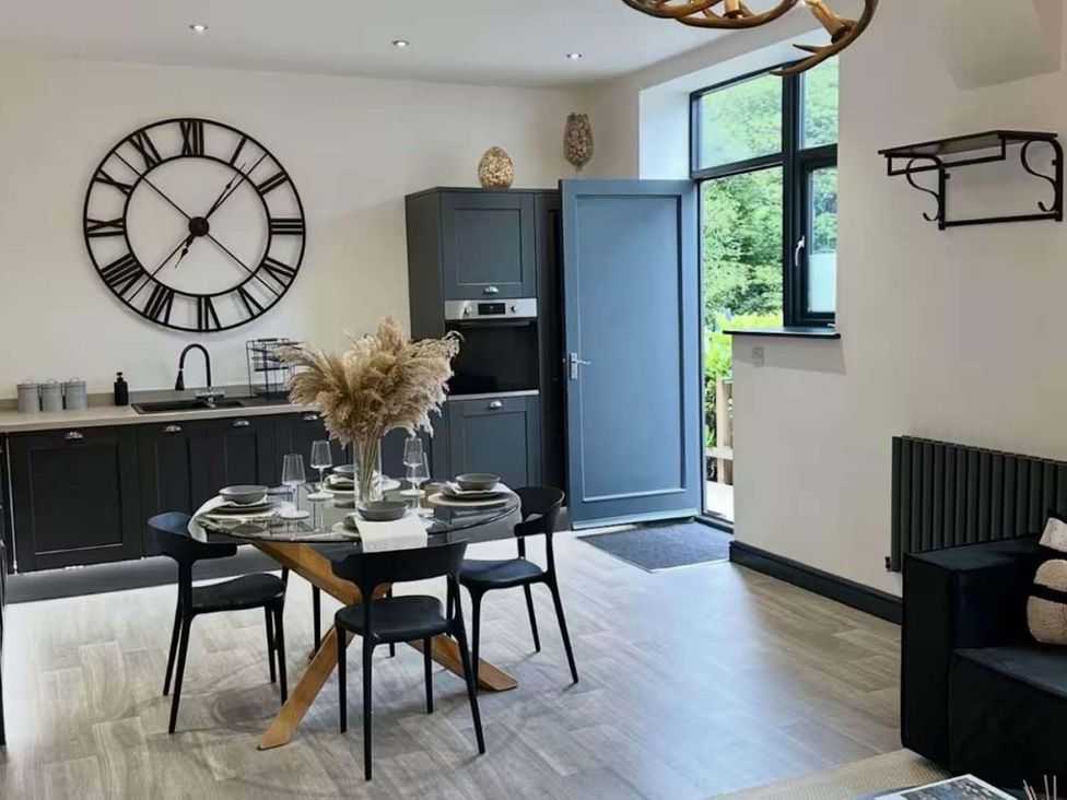 A kitchen with dining table and chairs at New Cosy Retreat in Matlock Bath