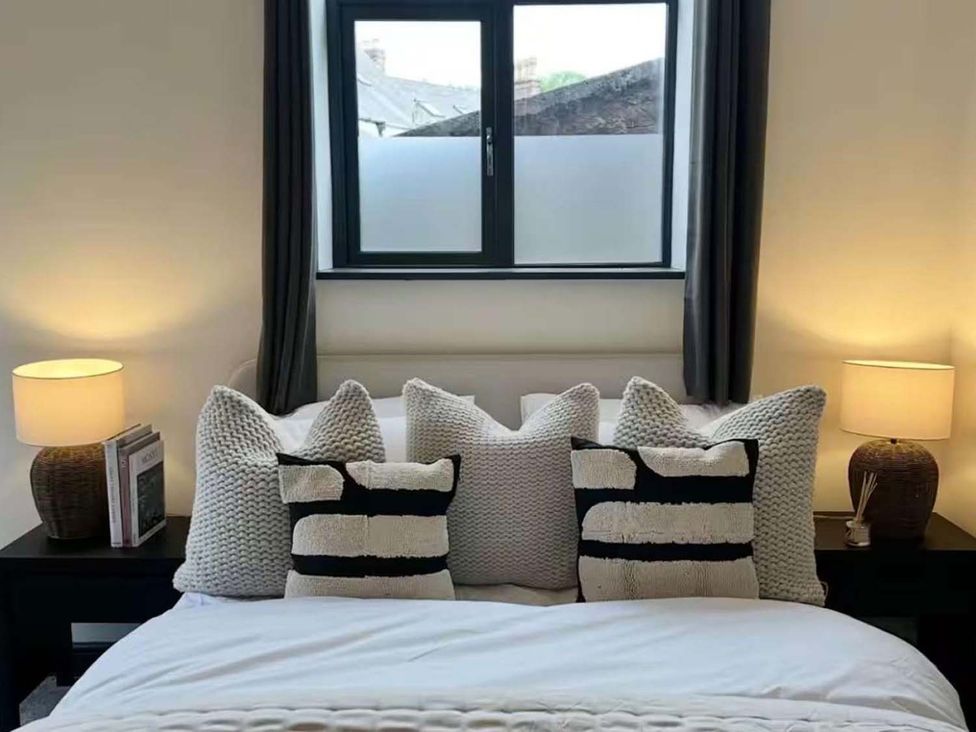 A bedroom with a bed and pillows at New Cosy Retreat in Matlock Bath