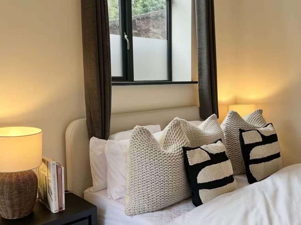 A bedroom with a bed and pillows at New Cosy Retreat in Matlock Bath