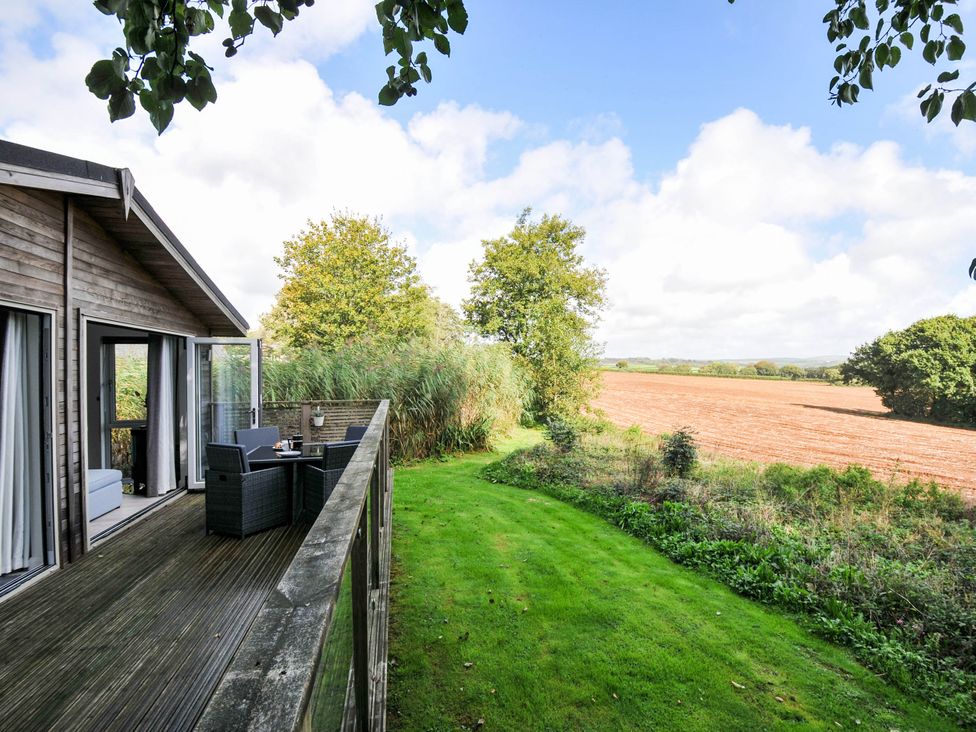 An outdoor area with a deck and seating at 22 Meadow Retreat Dobwalls
