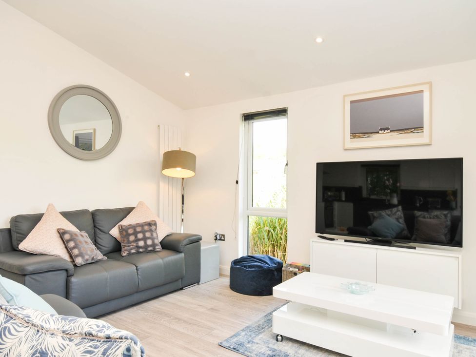 A living room with a sofa and TV at 22 Meadow Retreat in Dobwalls
