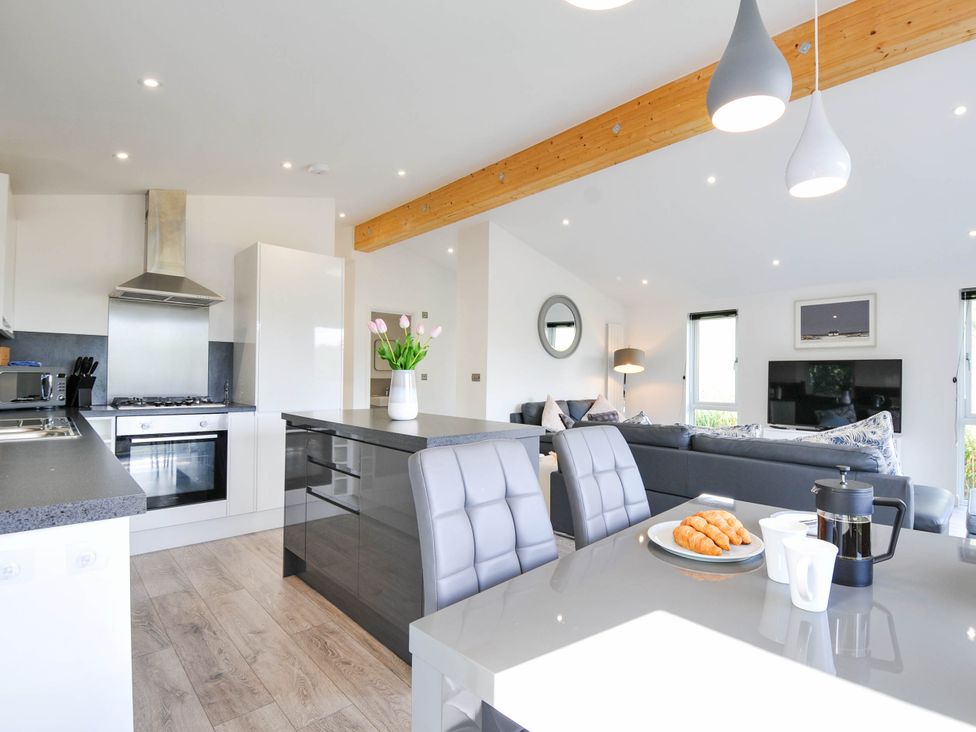 A kitchen with stainless steel appliances and dining area at 22 Meadow Retreat in Dobwalls