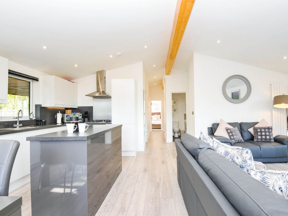 A kitchen and living room area with a sofa at 22 Meadow Retreat in Dobwalls