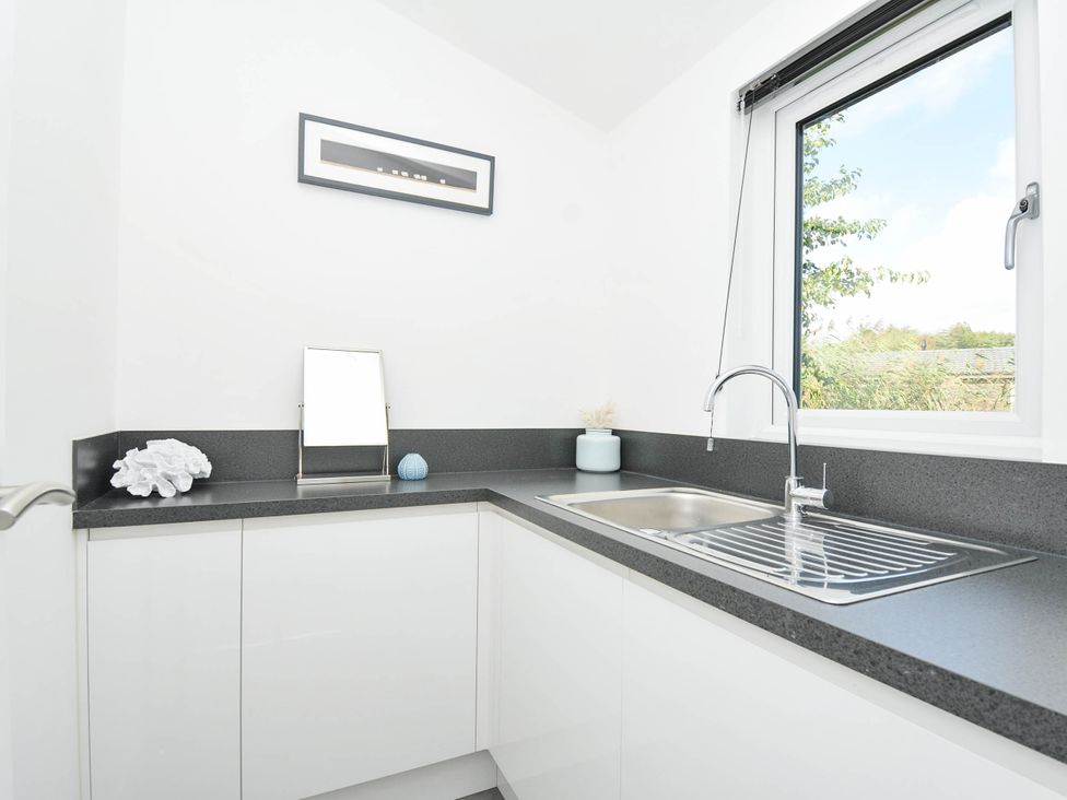 A kitchen with a sink and cabinets at 22 Meadow Retreat in Dobwalls