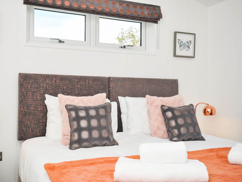 A bedroom with a bed and decorative pillows at 22 Meadow Retreat in Dobwalls