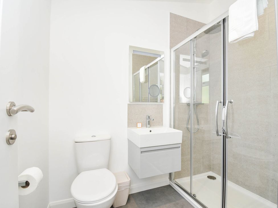 A bathroom with a toilet, sink, and shower at 22 Meadow Retreat in Dobwalls