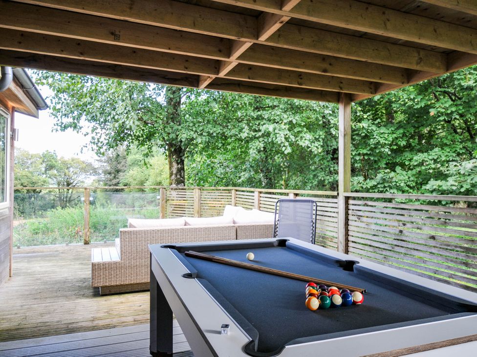 A pool table with balls and cue stick on a deck at 22 Meadow Retreat in Dobwalls