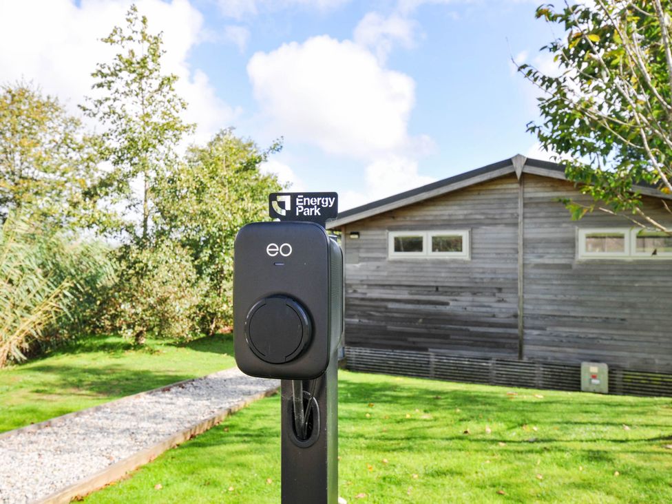 An electric vehicle charger in a garden area at 22 Meadow Retreat in Dobwalls