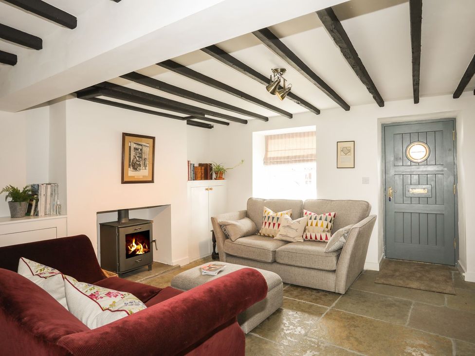 A living room with a sofa and fireplace at Swn y Mor (Wexham) Beaumaris