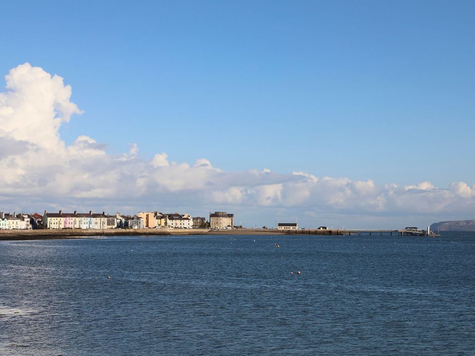 A coastal view with houses and a pier at Swn y Mor (Wexham) Beaumaris
