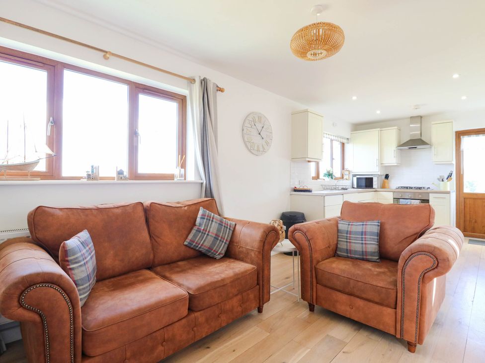 A living room with a sofa and armchairs at Elsie Lodge in Hastings