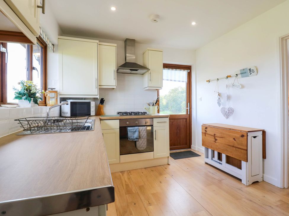 A kitchen with a sink and stove at Elsie Lodge in Hastings