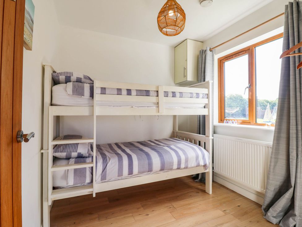 A bedroom with a bunk bed and window at Elsie Lodge in Hastings