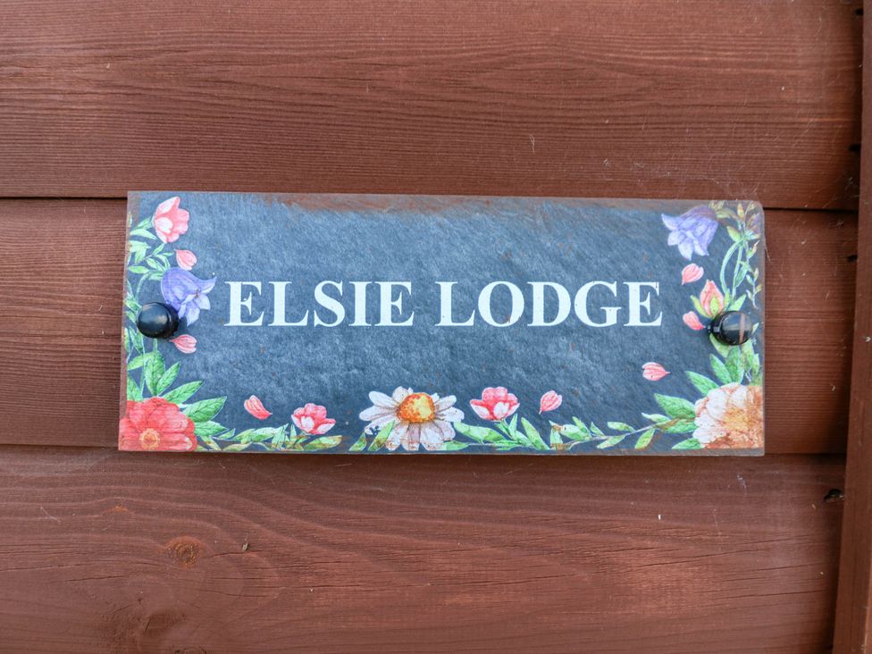 A sign with the name Elsie Lodge attached to a wall