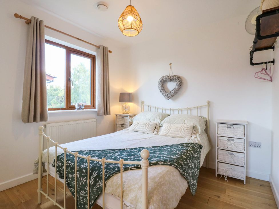 A bedroom with a bed and lamp at Rosie Lodge in Hastings