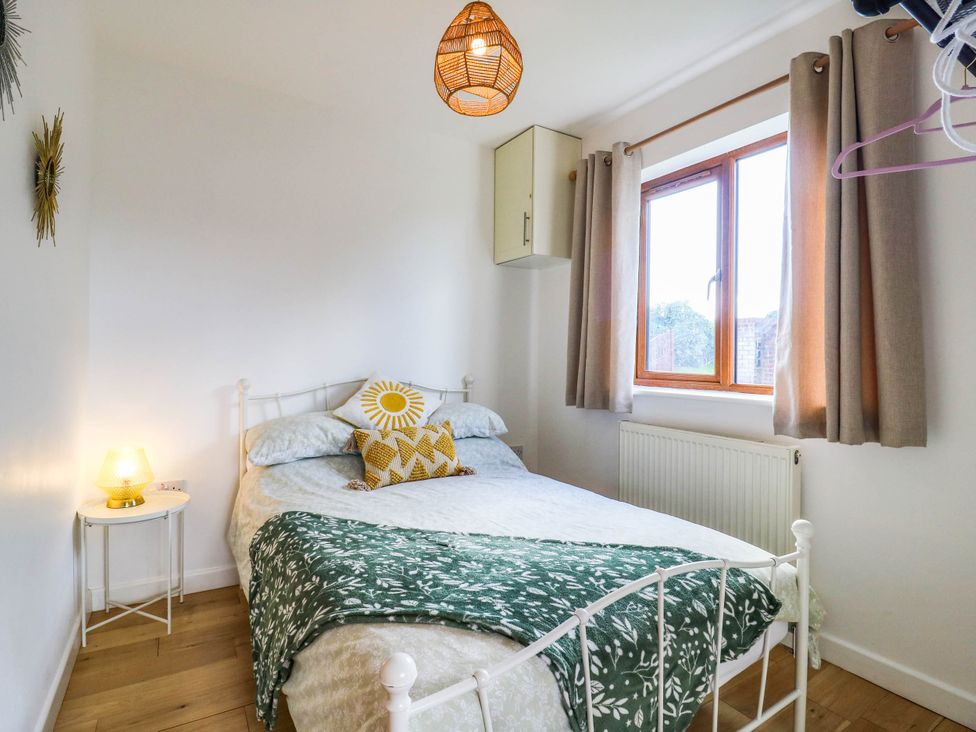 A bedroom with a bed and window at Rosie Lodge in Hastings