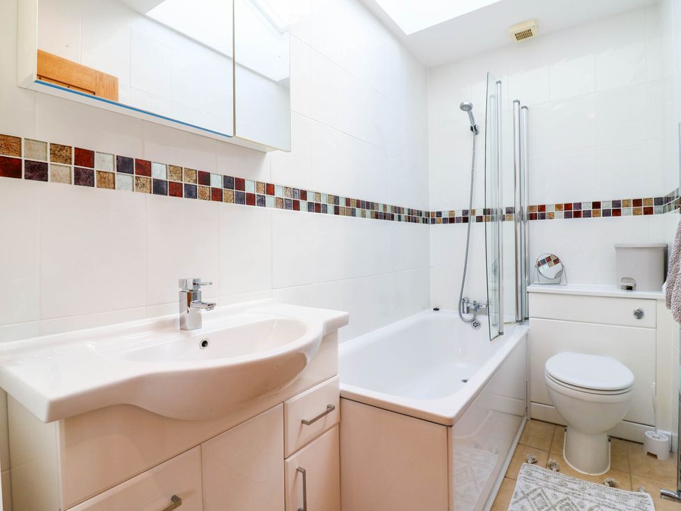 A bathroom with a wash basin a bath and a shower at Rosie Lodge in Hastings