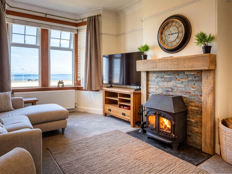 A living room with a fireplace and television at Fereneze, Lochranza, Isle Of Arran