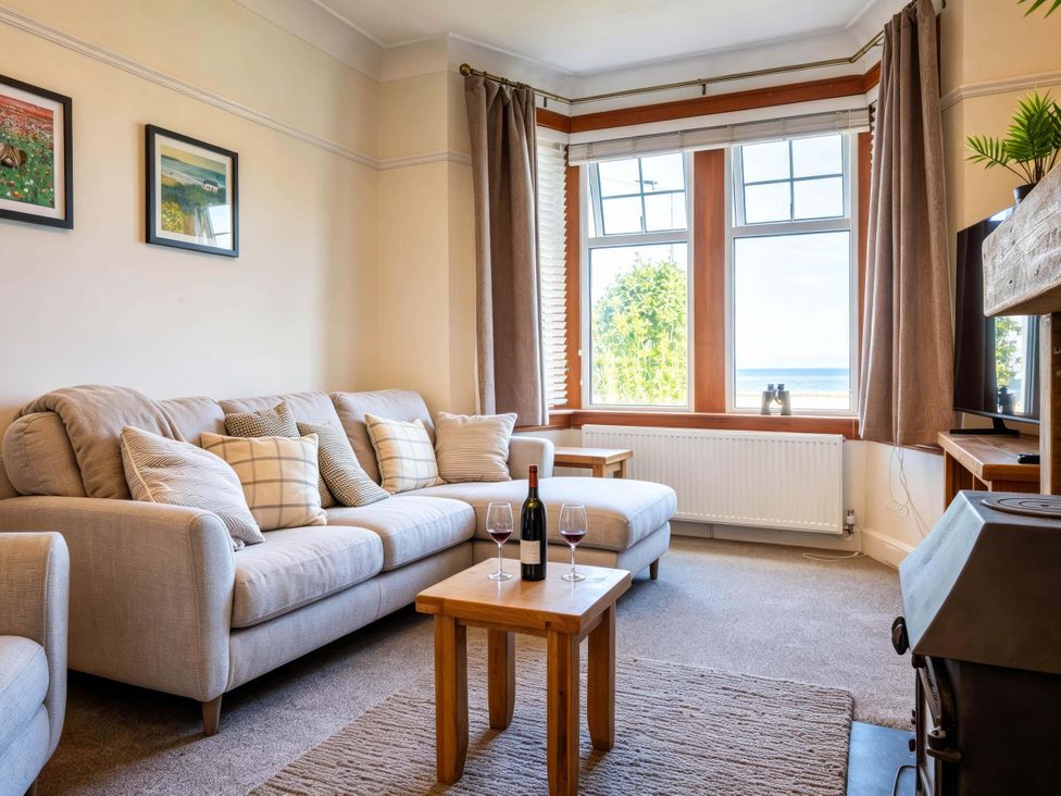 A living room with a sofa and coffee table at Fereneze, Lochranza, Isle Of Arran