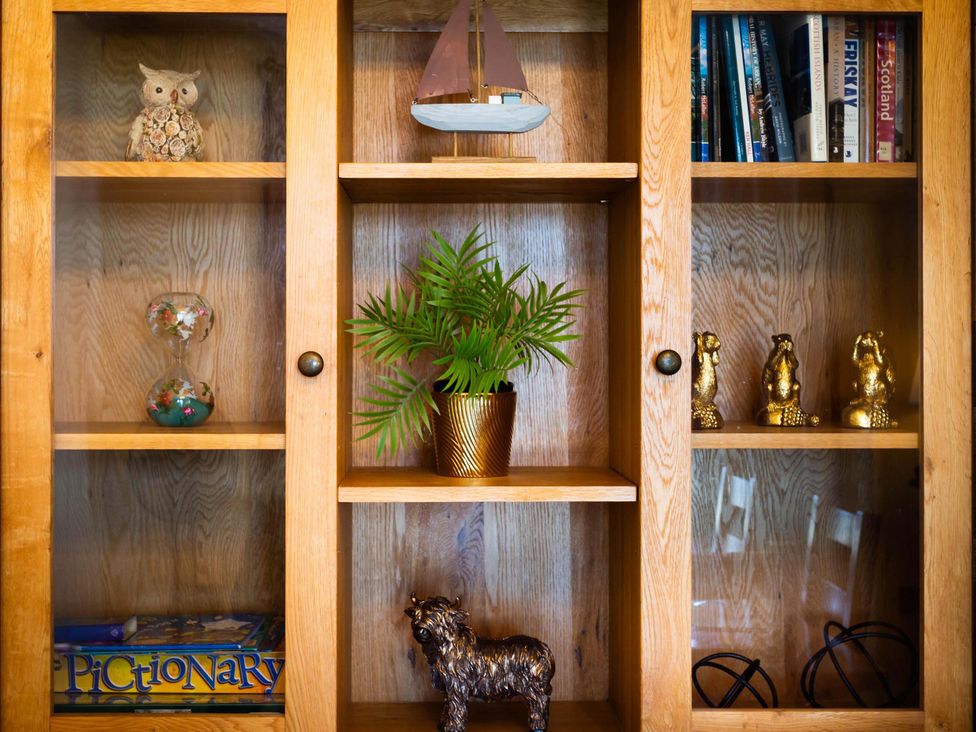 A display cabinet with various decorative items at Fereneze in Lochranza, Isle Of Arran