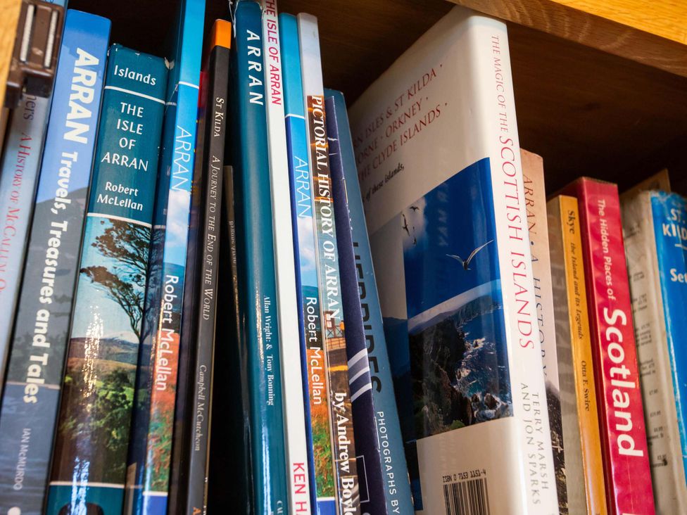 A collection of books on a shelf at Fereneze, Lochranza, Isle Of Arran