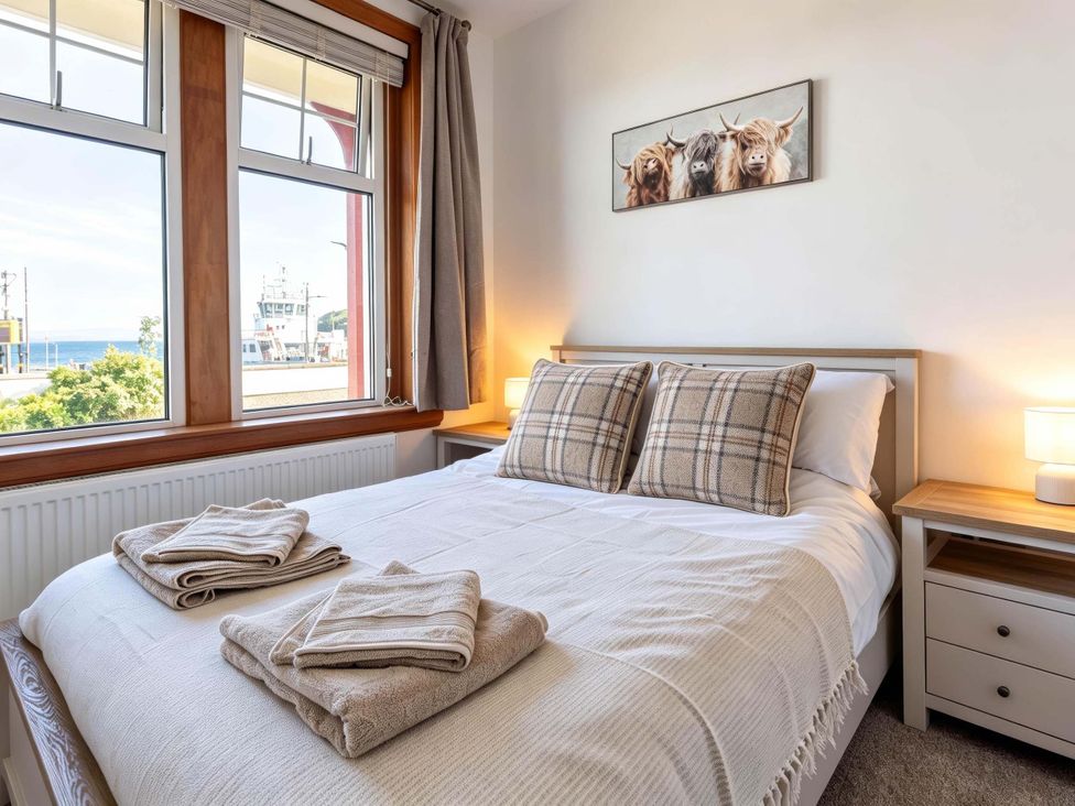 A bedroom with a bed and window at Fereneze, Lochranza, Isle Of Arran