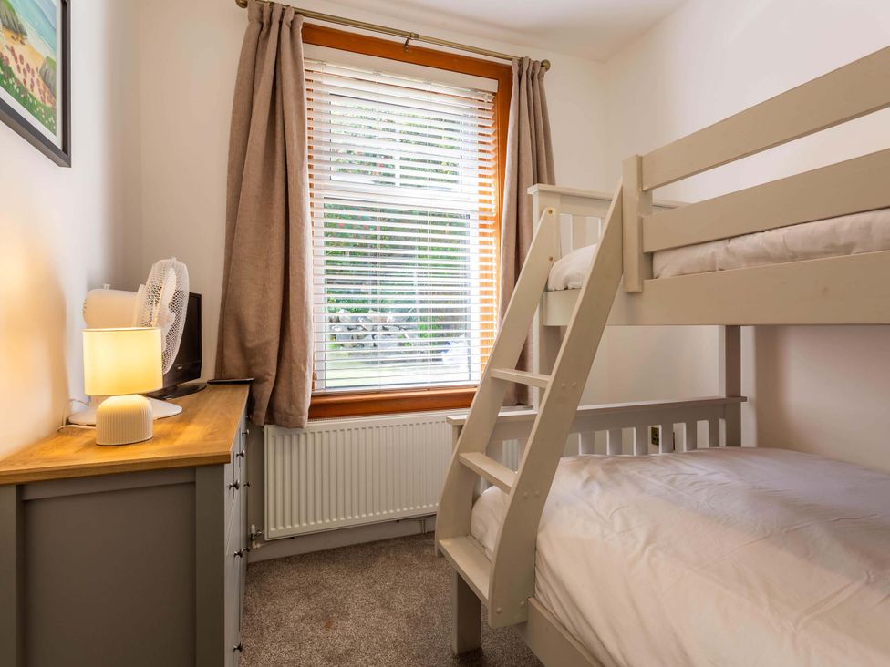 A bedroom with a bunk bed and dresser at Fereneze, Lochranza, Isle Of Arran